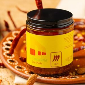 La Cenaduria Salsa Jar over a ceramic traditional dish and chilis